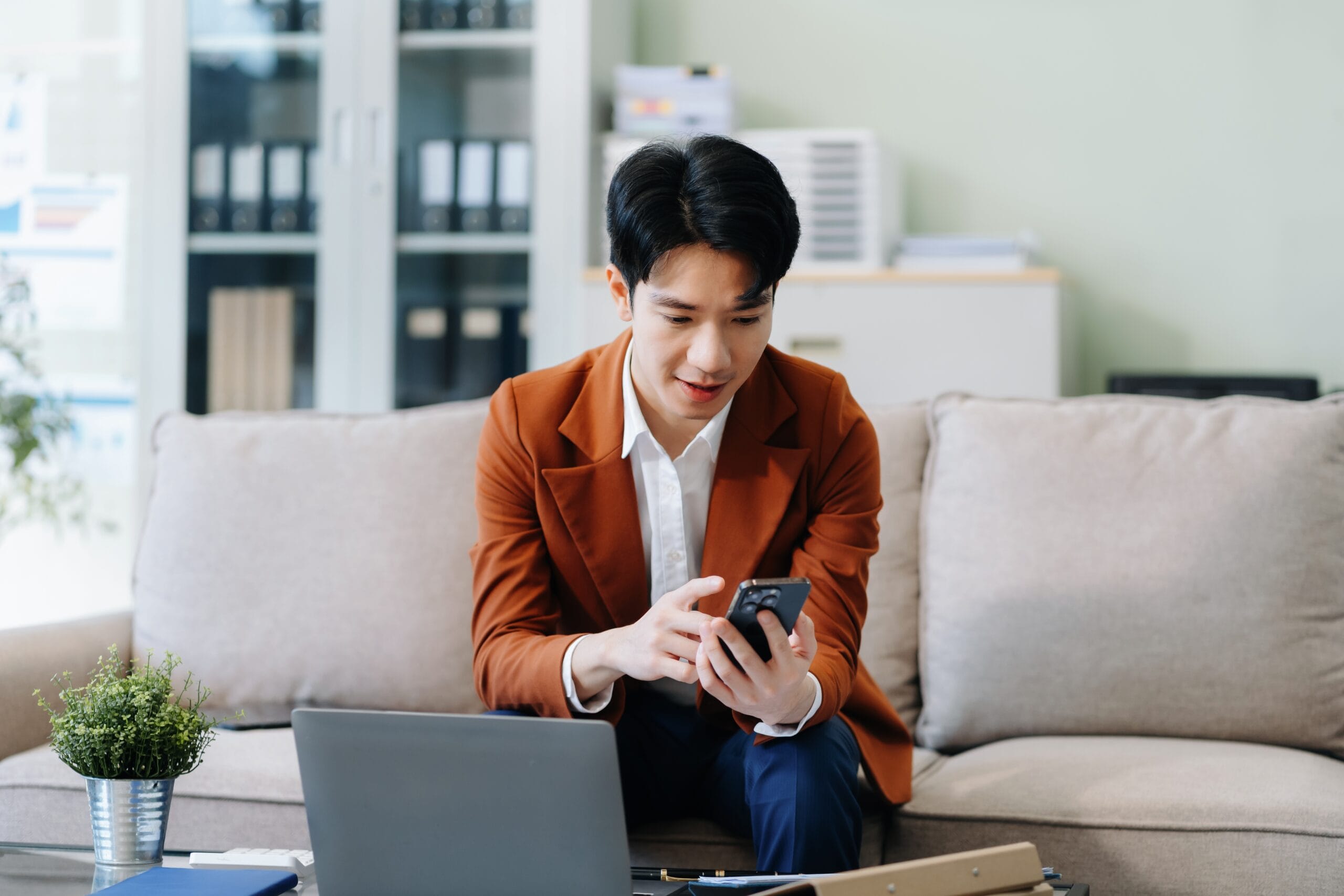 Young man scrolling through his phone